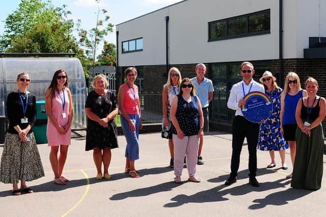 Parents of year-six pupils at Heron Way Primary School presented headteacher James Crump with a plaque to thank staff for keeping the children learning through lockdown. Picture: Charles Puckle SUS-200722-083510001