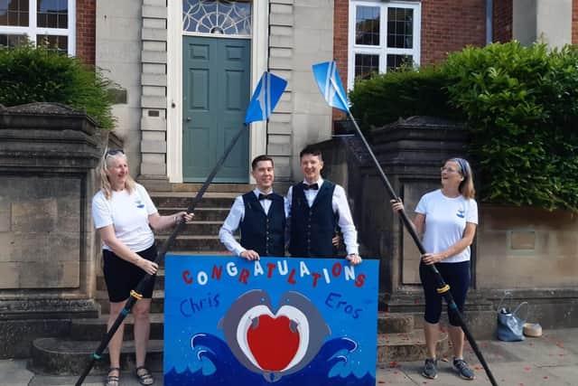 Chichester Rowing Club members formed an arch with oars for the couple outside Edes House