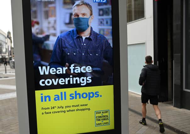 The wearing of face masks in shops in England became compulsory from today Friday, July 24 (Photo by OLI SCARFF/AFP via Getty Images) SUS-200724-153705001