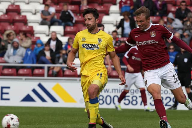 Chris Whelpdale in the yellow of AFC Wimbledon taking on Northampton / Picture: Getty