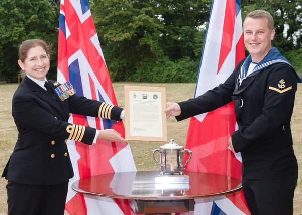 Jack Stait from Barnham, a leading aircraft controller in the Royal Nay, has been awarded the commodore's cup. He received his award from Commanding Officer of HMS Collingwood, Captain Catherine Jordan. Picture: Keith Woodland, Crown Copyright.