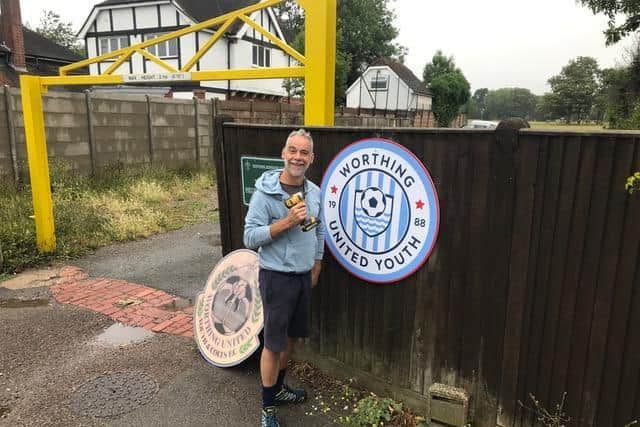 In with the new - football dad Matt Rivers putting up the new Worthing United Youth FC badge at the entrance to the clubs Rotary Recreation Ground