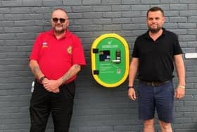 Paul Berry from the Billingshurst Emergency Assistance Team (BEAT) with Will Pasfield, director of Bellmans (right) and the new defibrillator in Wisborough Green SUS-200308-153309001