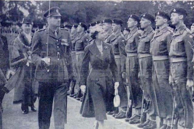 The Queen inspecting a military guard of honour in Priory Park in 1956