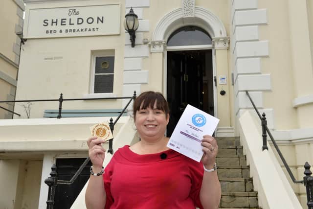 Judith Brown with her 'Plastic Free Champion' certificate outside her Sheldon B & B   (Photo by Jon Rigby)