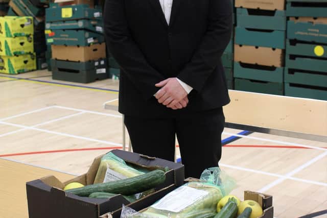 Labour leader Peter Lamb with food parcels sent out to residents