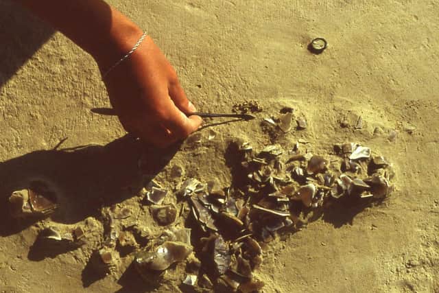 4. A small knapping scatter relating to the reshaping of a biface, preserving the imprint of an early human knee in the shards of waste flint, under excavation in 1989 (Copyright UCL Institute of Archaeology)