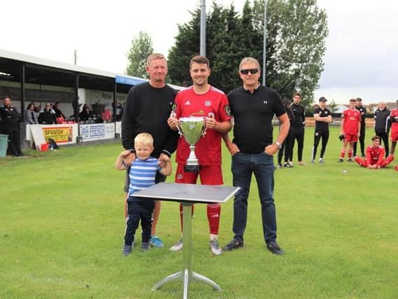 Worthing's Ollie Pearce with the Dave Kew Cup / Picture: Roger Smith