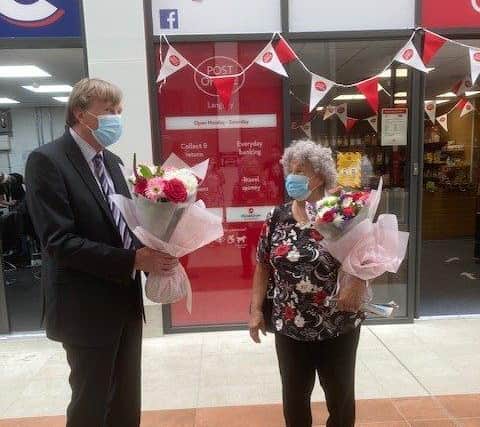Councillor Alan Shuttleworth presenting flowers to Anna Hooper, who collected 5,000 signatures for a petition to reopen Langney Post Office