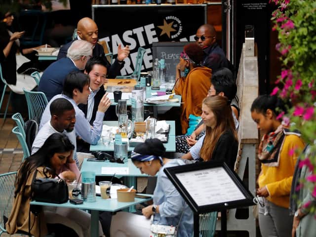 Diners sit at tables outside a restaurant as the Government's "Eat out to Help out" coronavirus scheme gets consumers spending again