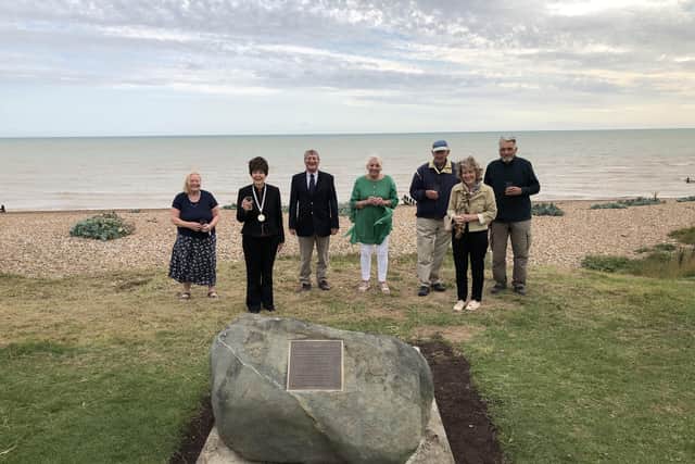 A boulder marker for a drowned chapel off the coast of Kingston, West Sussex, has been unveiled. Toasting the stone is Val knight, Kingston Parish Council clerk and councillors Geraldine Walker, Roger Wetherell, Valerie Masson, Peter Jolly, Karen Kenning and Keith Buckenham