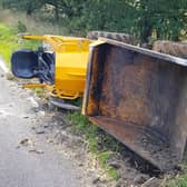 A digger appears to have fallen off the back of a lorry on the A272. Photo: Chichester Police