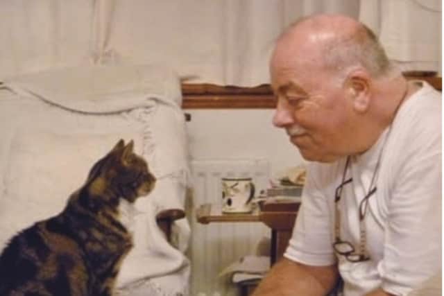 Ian Milton with one of the family cats
