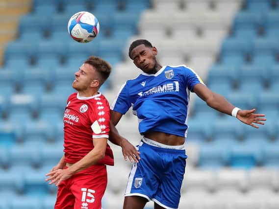 Archie Davies in an aerial battle with Gillingham's Zech Medley