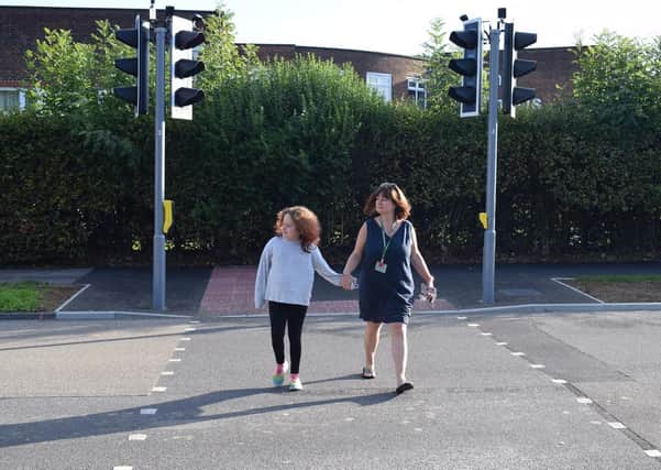 West Green Primary School Business Manager Annette Tomsettis pictured trying the new crossing with her daughter before the school reopened