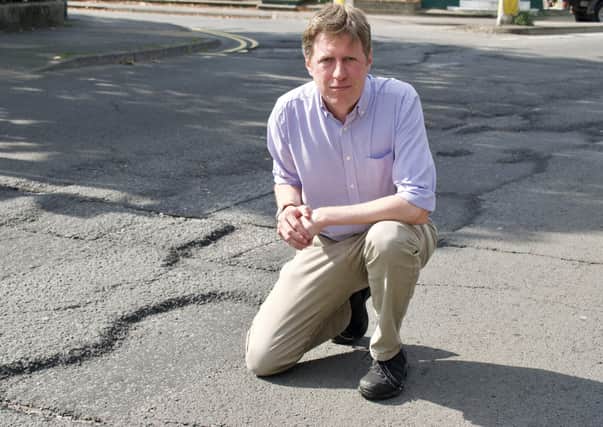 James MacCleary showing the damage to the Newhaven Ring Road (Photo by George Taylor)