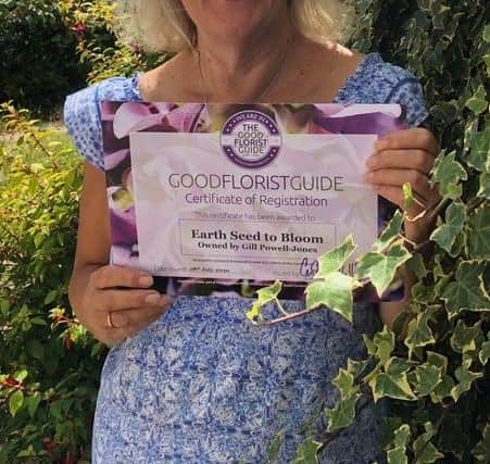 Gill Powell-Jones, owner of Earth Seed to Bloom, with her certificate from the Good Florist Guide