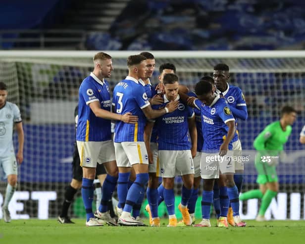 Brighton players celebrate after Leandro Trossard scores against Chelsea
