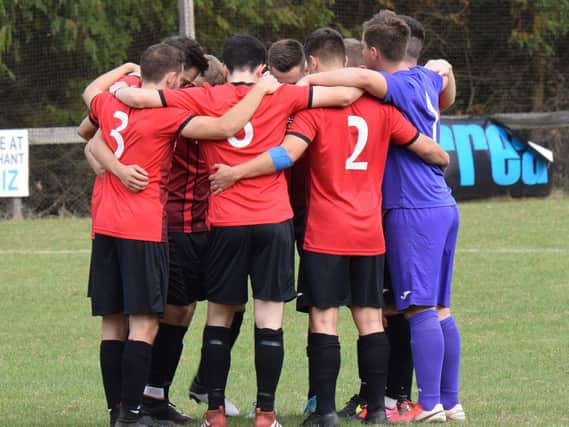 AFC Uckfield Town huddle before the game. Picture by Mike Skinner