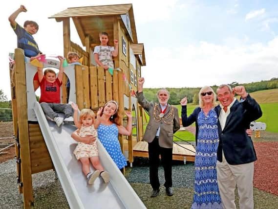 Brighton & Hove Mayor Alan Robins joins Jamie and Vivien Hooper to welcome some of the first visitors to the new Stanmer Park playground.