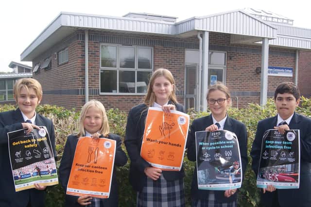 Year seven students from Felpham Community College with some of the posters which are on display