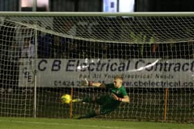 Louis Rogers makes a save in the shootout v Chesham to help send Hastings into the next round / Picture: Scott White