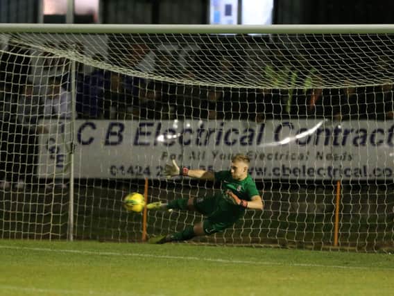 Louis Rogers makes a save in the shootout v Chesham to help send Hastings into the next round / Picture: Scott White