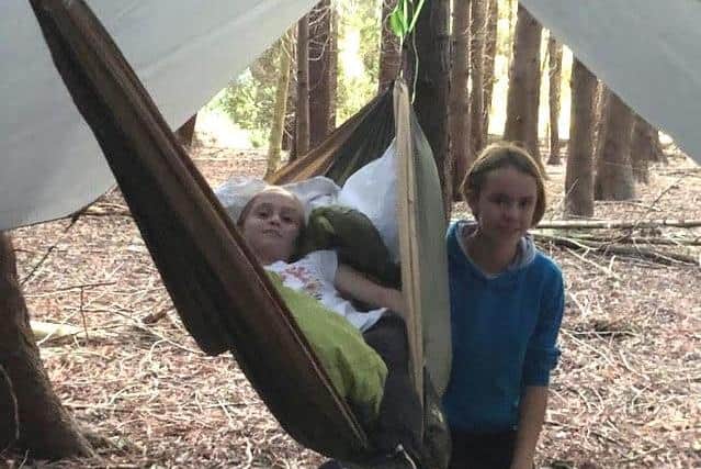 Ellie Aungier and Bronwyn Marshall camped out in the woods in hammocks to raise money for Crisis