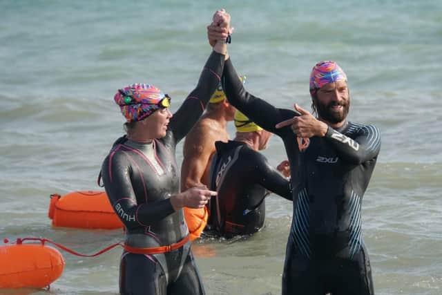 Nikki Gatland and Jon Cassell at the end of the 11-hour, 19-mile swim. Picture: Phil West