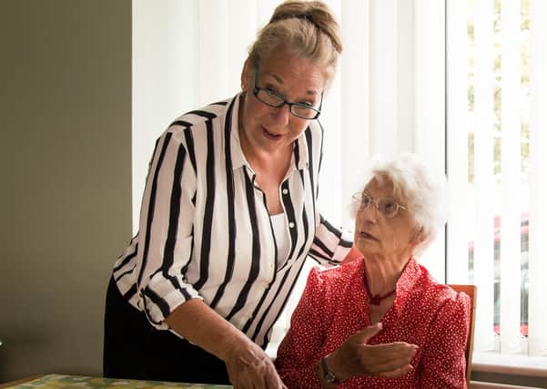 Jackie Woollett with one of the elderly residents. Photo by Kelvin Schafli