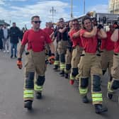 David Mayfield with firefighters walking from Shoreham Fire Station to Brighton Palace Pier