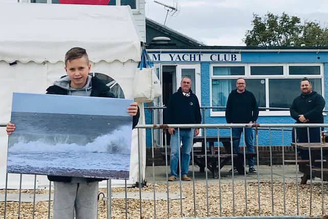 George Sedgwick with his winning canvas print, Pagham Yacht Club commodore Paul Palmer, George’s dad Matt Sedgwick, and vice commodore Rocky Robinson