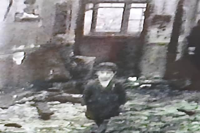 A still taken from the cine-camera film of John Snelling as a boy in the ruins of Victory Road School