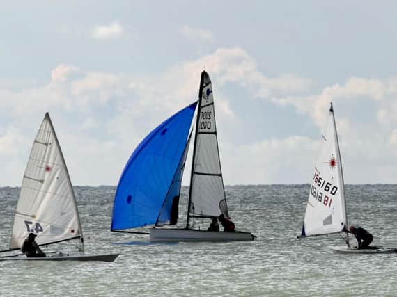 Richard and Sue Morley in the their Buzz, centre, ease ahead on the downwind leg / Picture: Rick Pryce