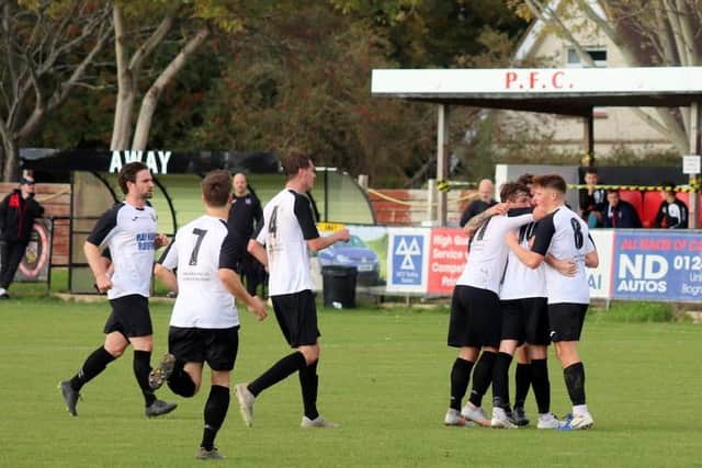 Pagham celebrate a goal v AFC Uckfield / Picture: Roger Smith