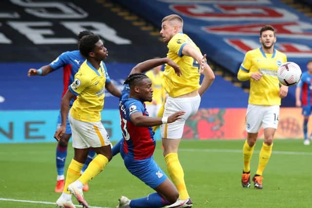 Palace striker Michy Batshuayi crumples to the floor after a brush from Tariq Lamptey
