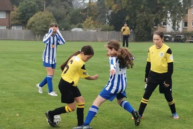 Player of the match Leticia Terry (left) and goalscorer Imogen Beasley in action for Wasps’ Under-12s against Horsham Sparrows.
