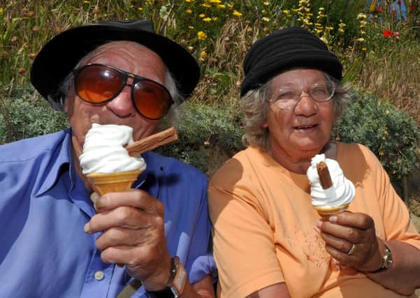 Couple enjoying an ice cream on Eastbourne seafront