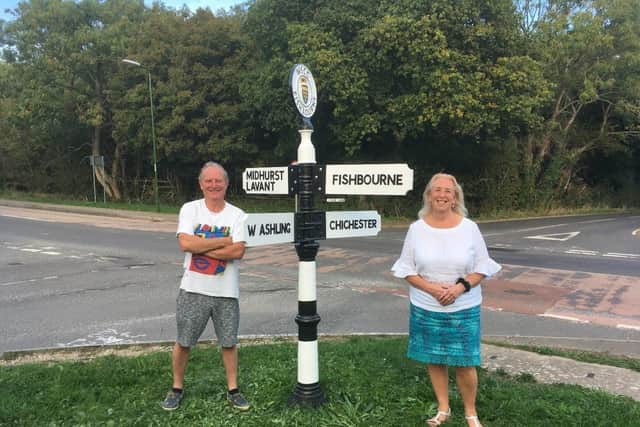 Gary Mason and Lynda Hunter with the refurbished Clay Lane fingerpost