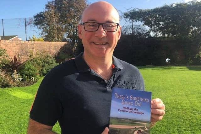 Simon Donlevy with his book There's Something Going On! about walking the Camino de Santiago