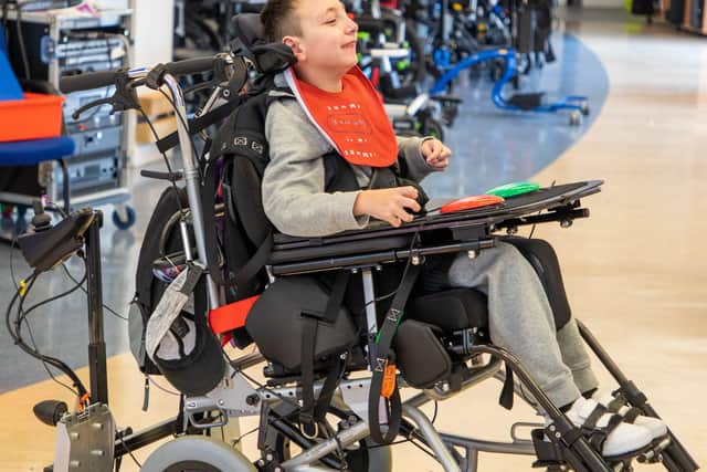 A young person from Chailey Heritage using Martin's powered platform base adapted wheelchair SUS-200311-101238001