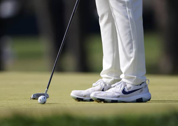 MAMARONECK, NEW YORK - SEPTEMBER 20: A detailed view of shoes worn by Matthew Wolff of the United States and his golf ball are seen as he plays the fifth green during the final round of the 120th U.S. Open Championship on September 20, 2020 at Winged Foot Golf Club in Mamaroneck, New York. (Photo by Jamie Squire/Getty Images) 775478206