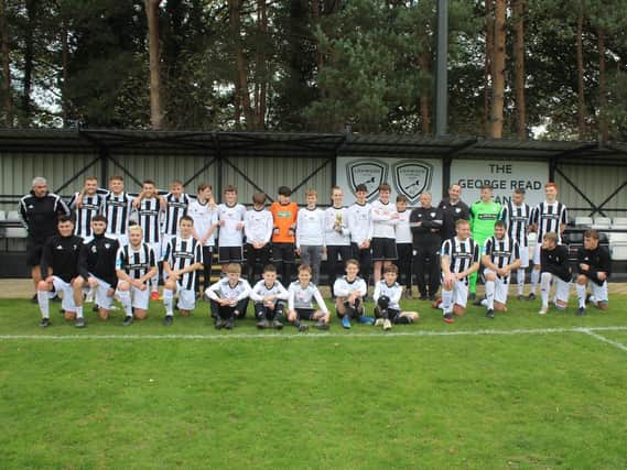 Loxwood under-14s show off their cup with the first team
