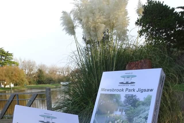 The 1,000-piece Mewsbrook Park puzzle features a beautiful scene of the park's iconic art deco shelter