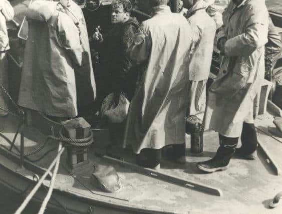 The Selsey lifeboat in Portsmouth landing the 18 survivors in 1956 - George, with cap on, has his back to the camera