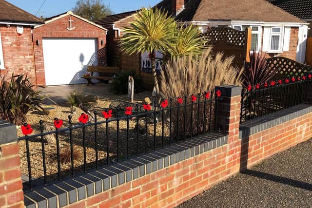 Janet Bugden knitted poppies for a Remembrance display along her front railings