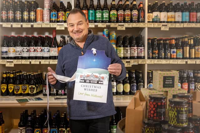 Andrew Chiverton, owner of The Crafty Pint in West Street Midhurst with the Chichester District Council Shop Local tag. Photograph by Christopher Ison