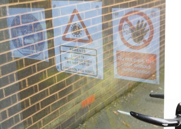 Covid schools guidance signs  (Photo by OLI SCARFF/AFP via Getty Images)