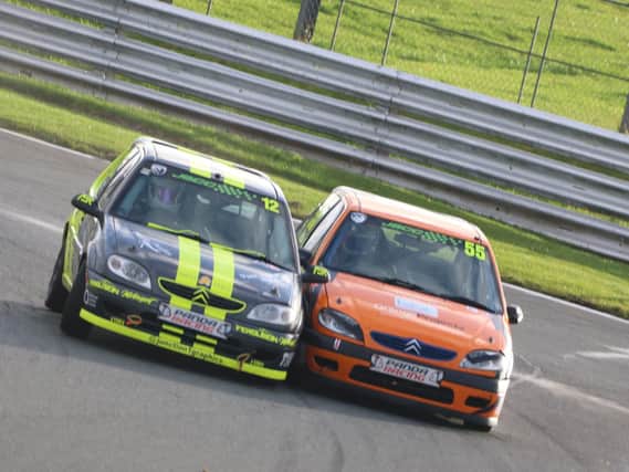 Charlie Hand, in the orange car, at Oulton Park