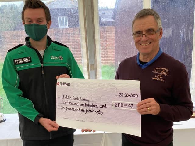 Chichester vets captain Colin Westwood presents the fundraising proceeds to St John Ambulance